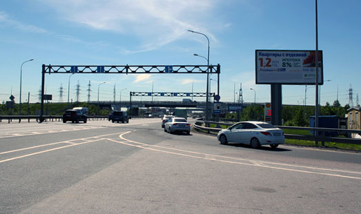 Щит на Мурманском шоссе, 12 км 700 м; въезд-выезд к «МЕГА Дыбенко», cторона А - в СПб