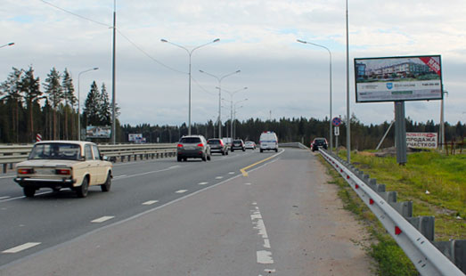 Щит на Новоприозерском шоссе, 9 км 80 м, cторона А - в СПб